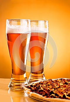 Two glass of beer and pizza