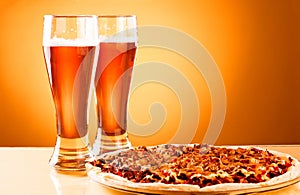 Two glass of beer and pizza