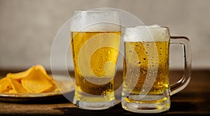 Two Glass of Beer and plate of Potato Chips on Table. Couple or Two Friends Drinking Beer Together Concept