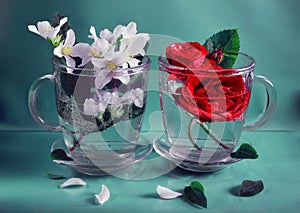 Two glass caps with white jasmine and red roses