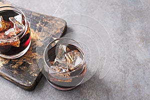 Two glass with cold cola and ice cubes