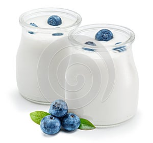 Two glass containers with plain yoghurt and berries isolated on white background
