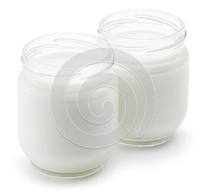 Two glass containers with plain yoghurt isolated on white background