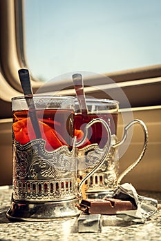 Train compartment with tea and cup holders.