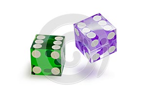 Two glass dice of different colors, green and blue, isolated on white, with a light shadow.
