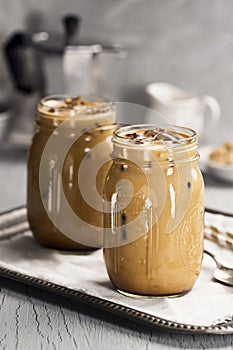 Two Glass Jars of Iced Coffee with Cream photo