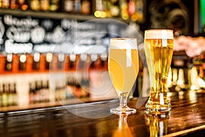 A two Glass of light beer on a pub with bokeh background