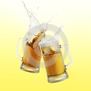 Two glass mugs of beer toasting with splash on color background