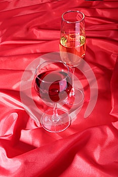 Two Glass of red, white wine on red background