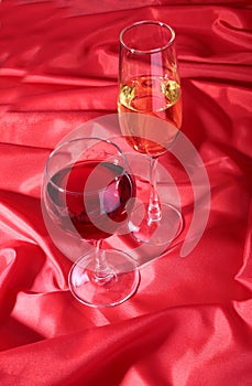 Two Glass of red, white wine on red background