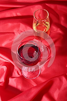 Two Glass of red, white wine on red background