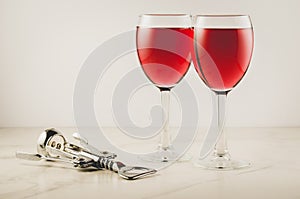 Two glass of red wine and corkscrew/ Two glass of red wine and corkscrew on white background. Selective focus