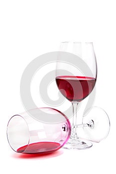 Two glass of red wine one of them lies photo