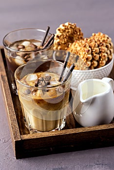 Two Glass of Tasty Cold Coffee on Wooden Tray Black Coffee and Coffee with Milk Refreshing Cold Summer Drink Vertical Bowl with