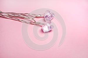 Two glass transparent hearts on soft pink background. Valentine& x27;s day symbol. Decorative element. Festive Valentine card
