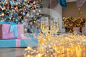 Two glasse of champagne on a Christmas New year background and decoration, light bokeh effect