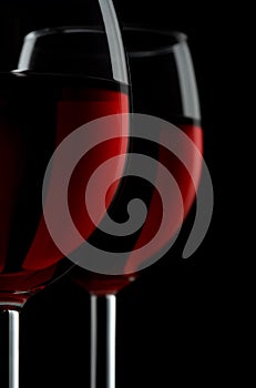 Two glassed of red wine isolated on black background