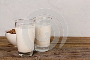 Two glasses with alternative dairy free buckweat milk. Lactose free beverage