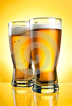 Two glasses of beer close-up with froth