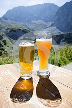 Two glasses of beer in mountain panorama