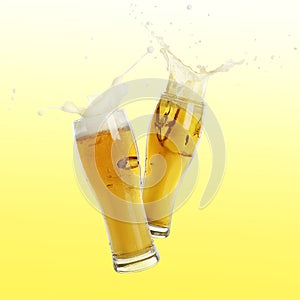Two glasses of beer toasting with splash on color background