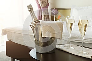 Two glasses and bottle of champagne in hotel