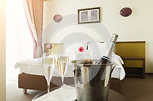 Two glasses and bottle of champagne in hotel