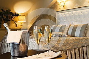 Two glasses and bottle of champagne in hotel