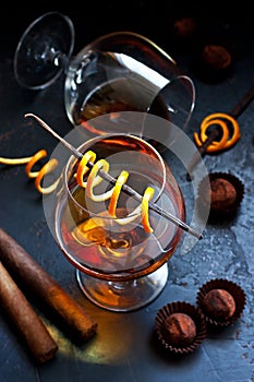 Two glasses of brandy or cognac on  dark table