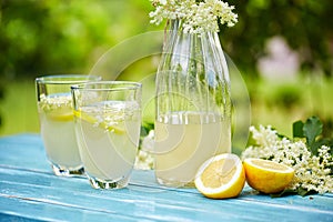 Two glasses and a carafe of elderflower lemonade