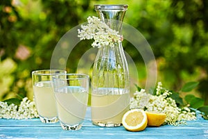 Two glasses and a carafe of elderflower lemonade