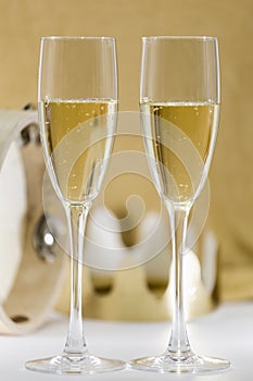 Two glasses of cava on golden background