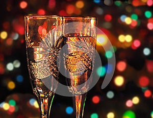 Two glasses with champagne against festive background