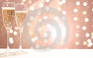 Two glasses of champagne on the background of festive garlands, copy space for your text on the right