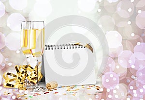 Two glasses of champagne and blank greeting card