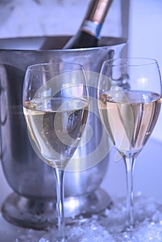 Two glasses of champagne and bottle in the bucket, vertical picture