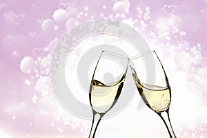 Two glasses of champagne on brillante background photo