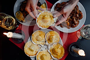 Two glasses of champagne, two candles, scallop in the hands of a woman