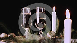 Two glasses with champagne with christmas decor background