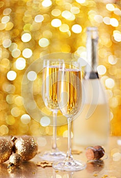 Two glasses of champagne with a Christmas decor in the background. very shallow depth of field, focus on near glass