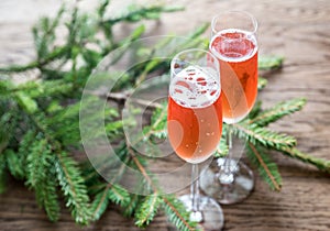 Two glasses of champagne with Christmas tree branch