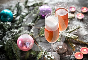 Two glasses of champagne with Christmas tree branch