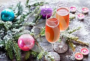 Two glasses of champagne with Christmas tree branch