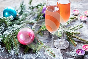 Two glasses of champagne with Christmas tree branch