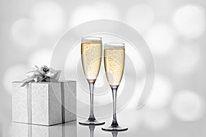 Two glasses of champagne on a festive light background