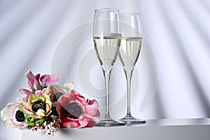 Two glasses with champagne and flowers