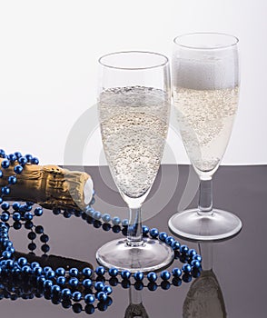Two glasses of champagne on a glowing white background