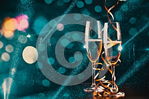 two glasses of champagne and holiday lights - new year celebration