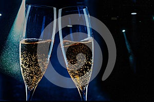 two glasses of champagne and holiday lights - new year celebration