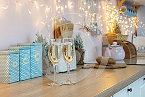 Two glasses of champagne on a kitchen. Christmas New year background and decoration